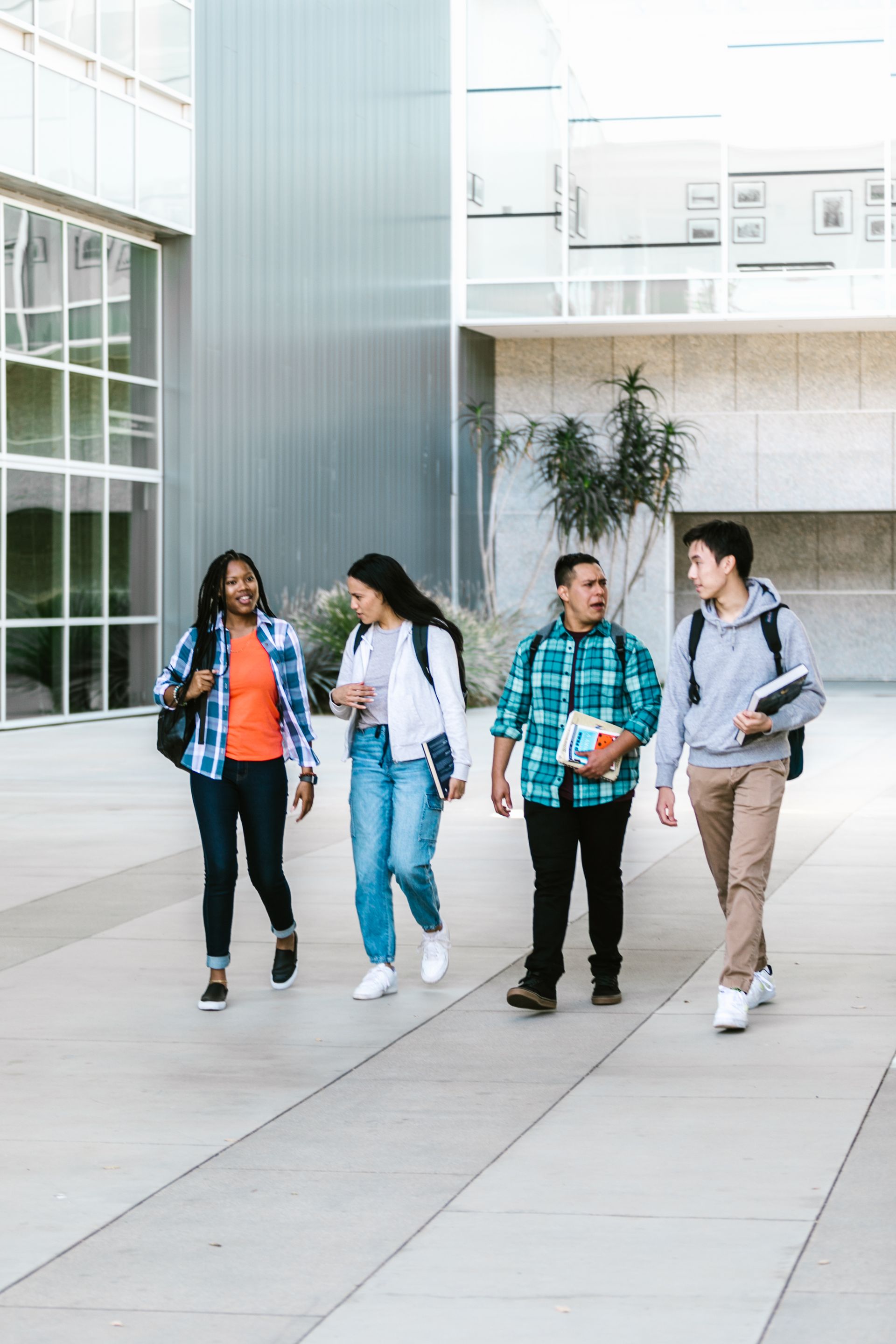 Group of international students walking together on a university campus